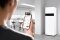 A man operates a Viessmann product using the Vicare app on a smartphone.